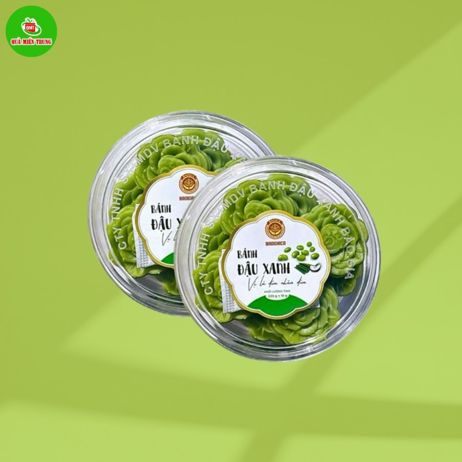Two round tubs of green mung bean flower shaped cakes on a green background with a gift store logo