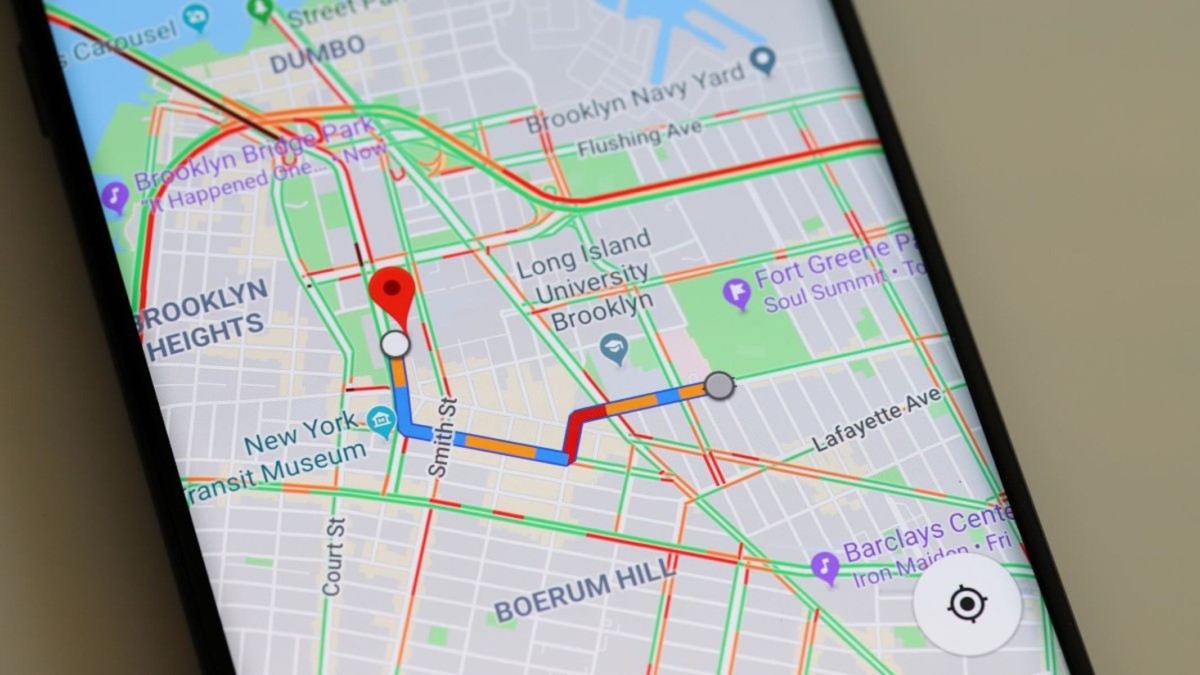 Smartphone displaying Google Maps with a highlighted transit route and traffic across a city street grid
