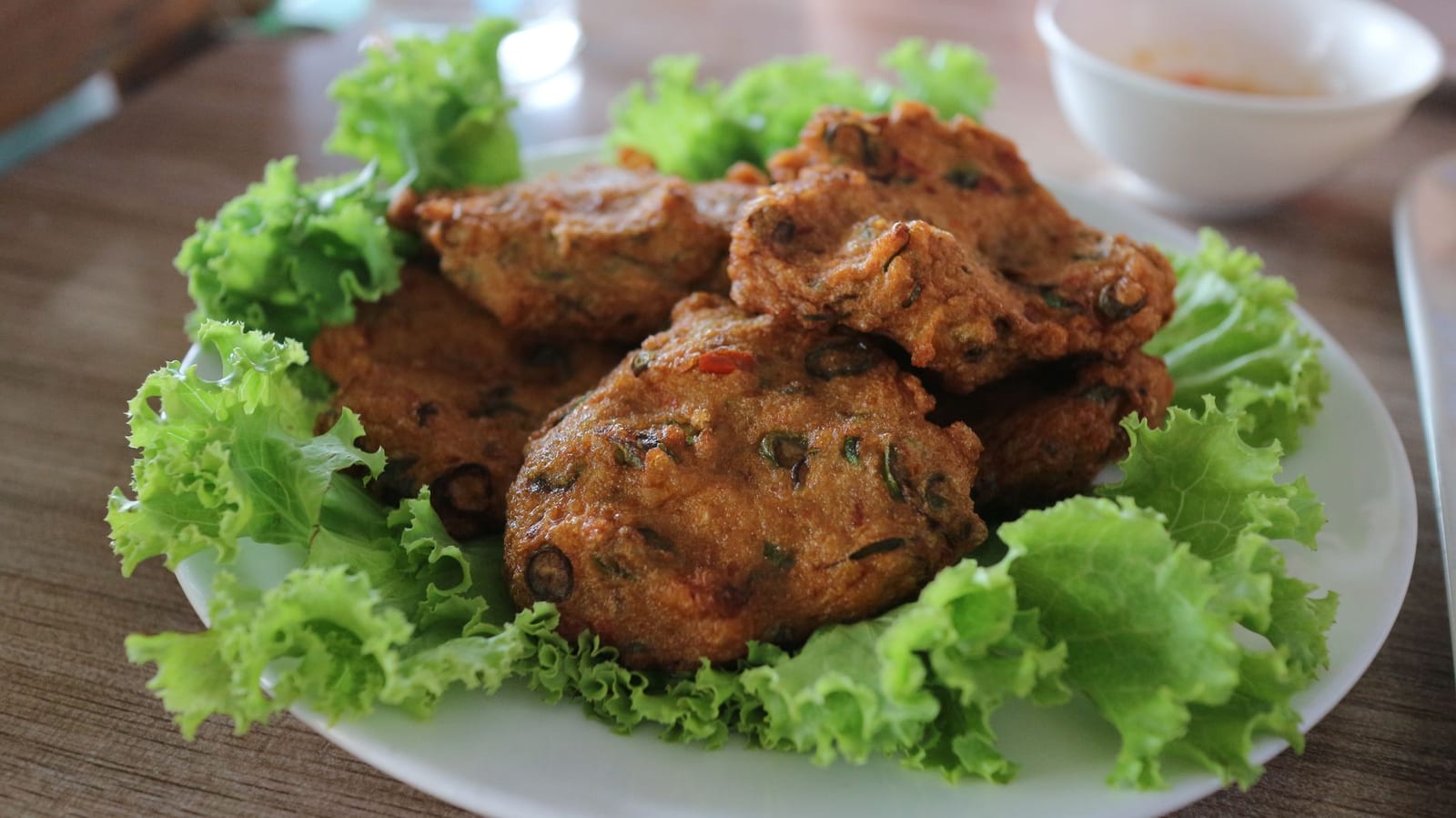A plate of Vietnamese fish cake — fried golden chả chiên and pale steamed chả hấp slices