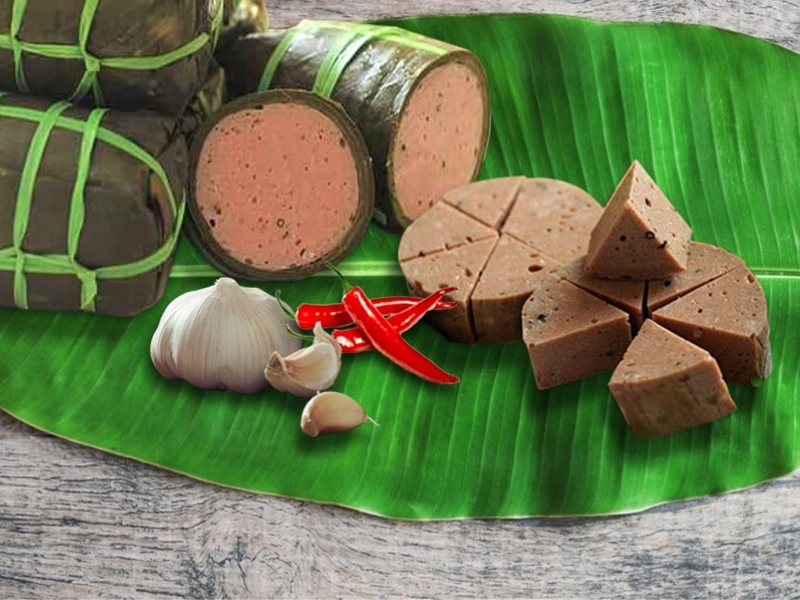Close-up of pink, springy beef sausage slices flecked with cracked black pepper