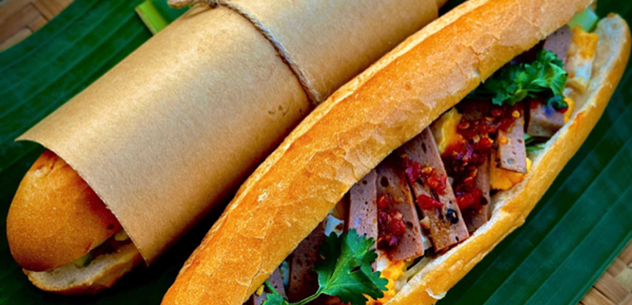 A Da Nang-style bánh mì filled with sliced sausage, herbs, pickled vegetables and chili
