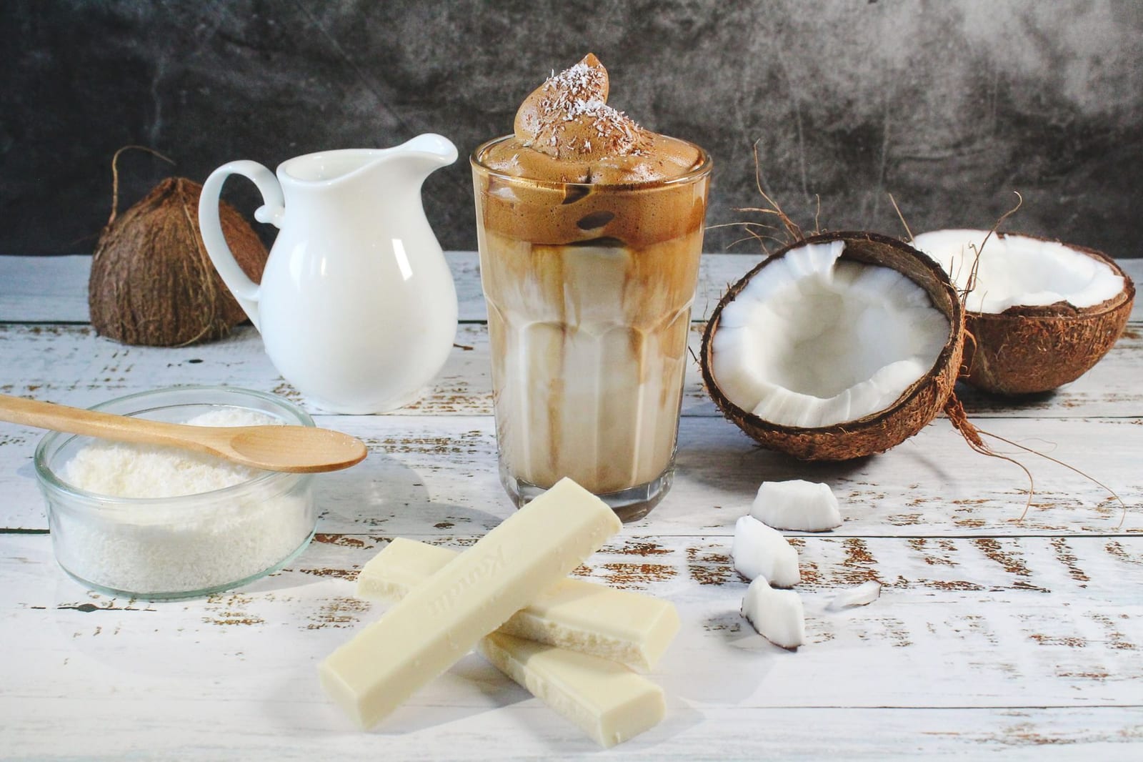 Iced Vietnamese coconut coffee topped with toasted coconut flakes in a tall glass.