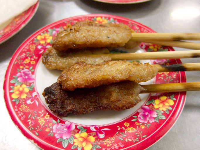 Grilled nem lụi minced-pork lemongrass skewers on bamboo sticks