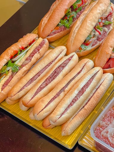 Trays of thin bánh mì que sticks filled with rich pâté and chili.