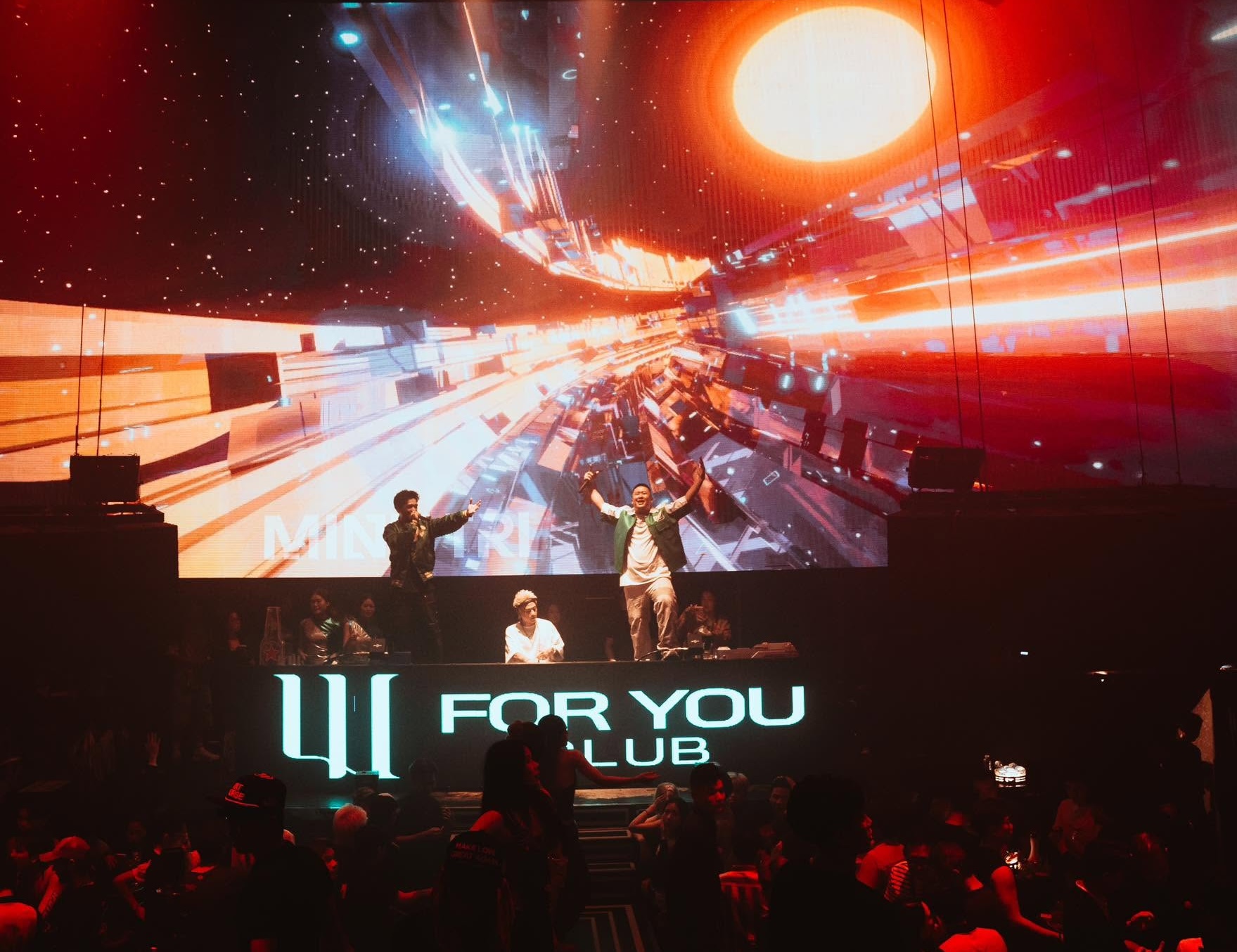 A huge wraparound LED screen and DJ booth above the dancefloor at For You Club in Da Nang.