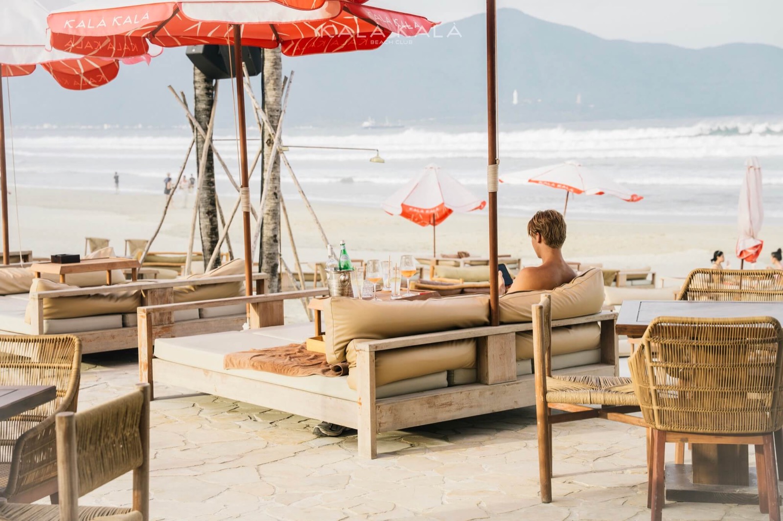 Beachfront day beds and parasols at Kalà Kalà Beach Club on My Khe Beach, Da Nang.