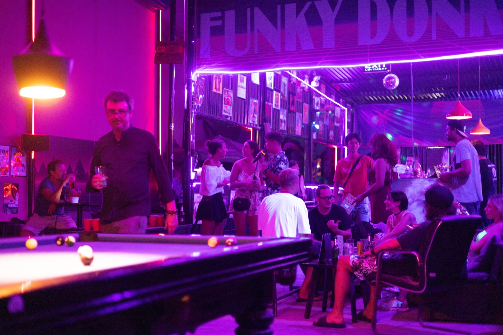 Pool table and neon-lit crowd at Funky Donkey, a party bar in the An Thuong quarter, Da Nang.
