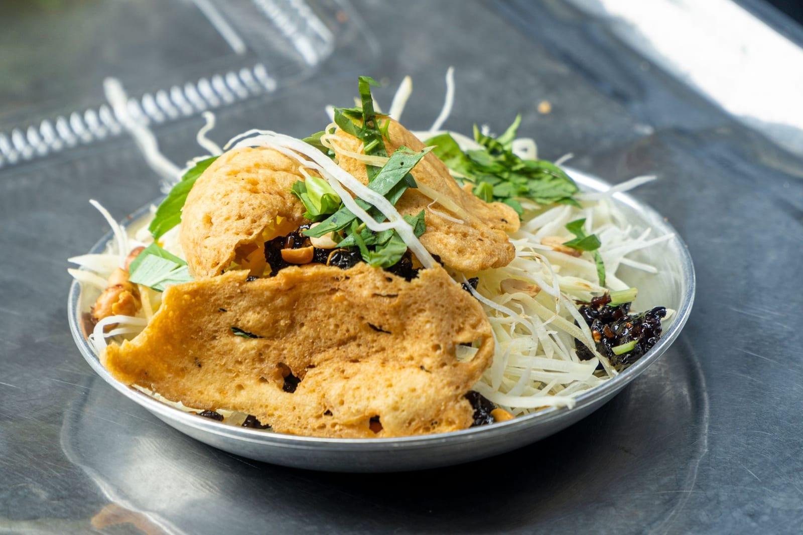 Mít trộn, Da Nang's young-jackfruit salad with peanuts and herbs, served with grilled rice crackers.