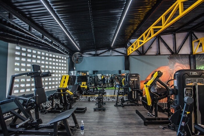 Inside a modern Da Nang gym, with weight machines and equipment across the floor.