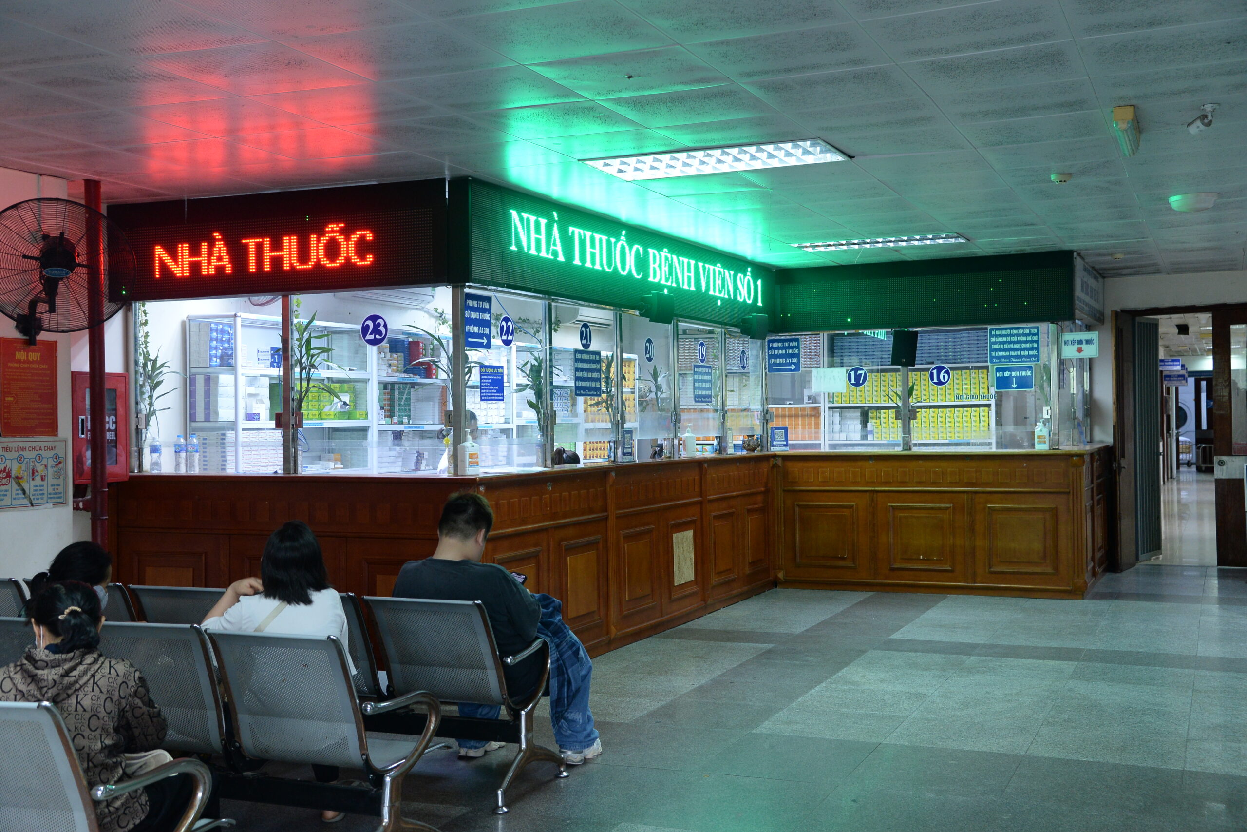 An in-hospital pharmacy counter in Da Nang, lit up in the evening