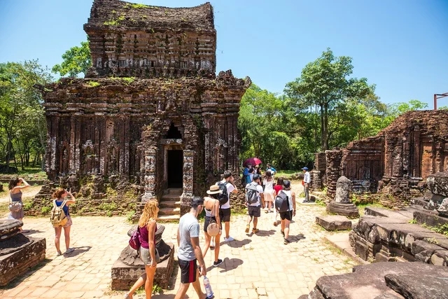 Weathered Cham brick towers among greenery, central Vietnam