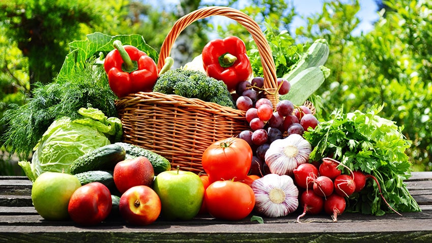 A basket of fresh vegetables and fruit, much like a weekly produce delivery.