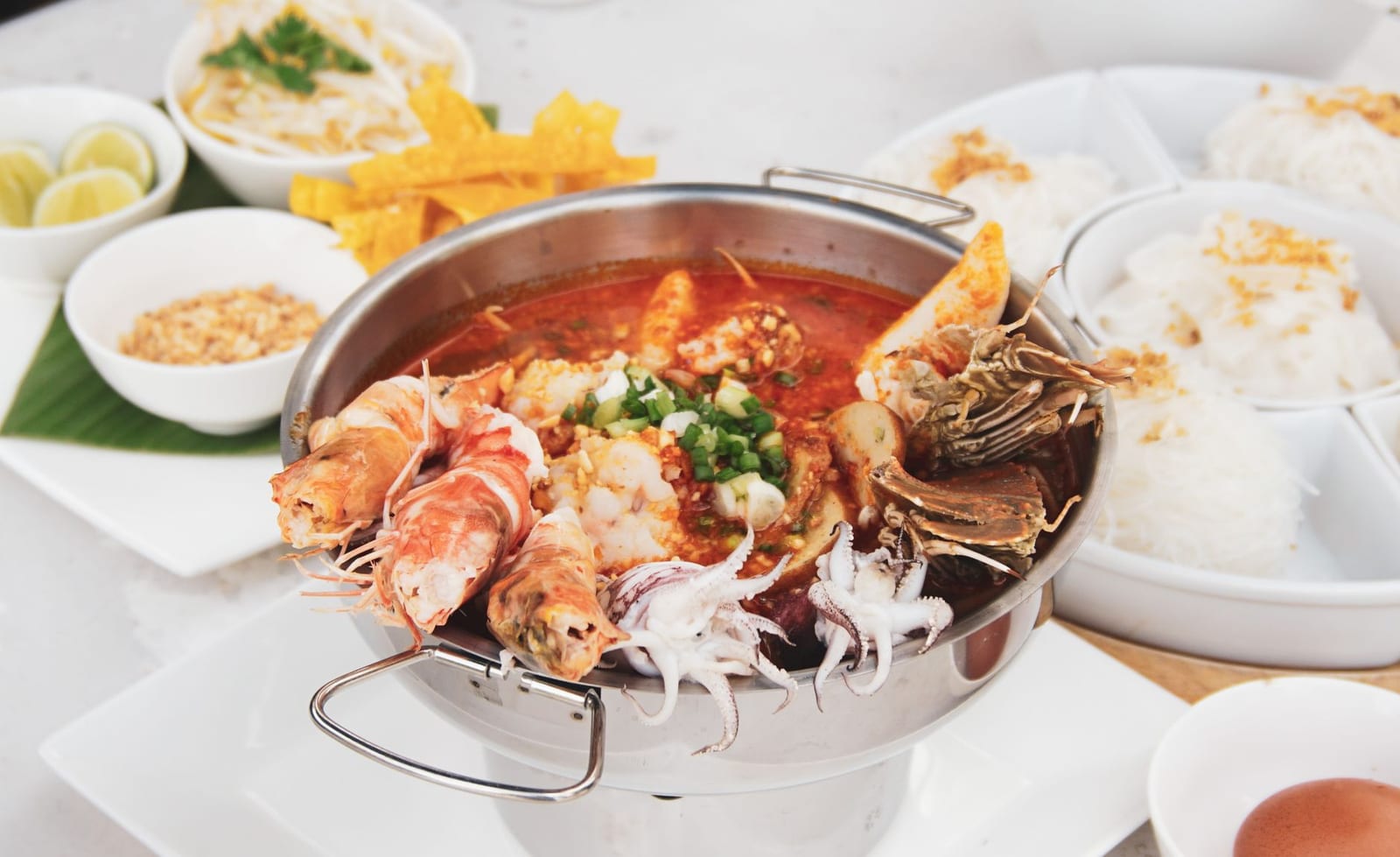 A steaming Vietnamese seafood hotpot with prawns, squid, clams and vegetables