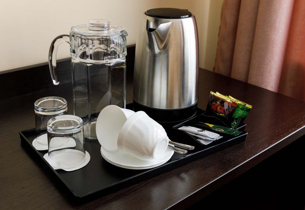 An electric kettle on a hotel counter, standard in Vietnamese hotels and apartments for boiling drinking water.