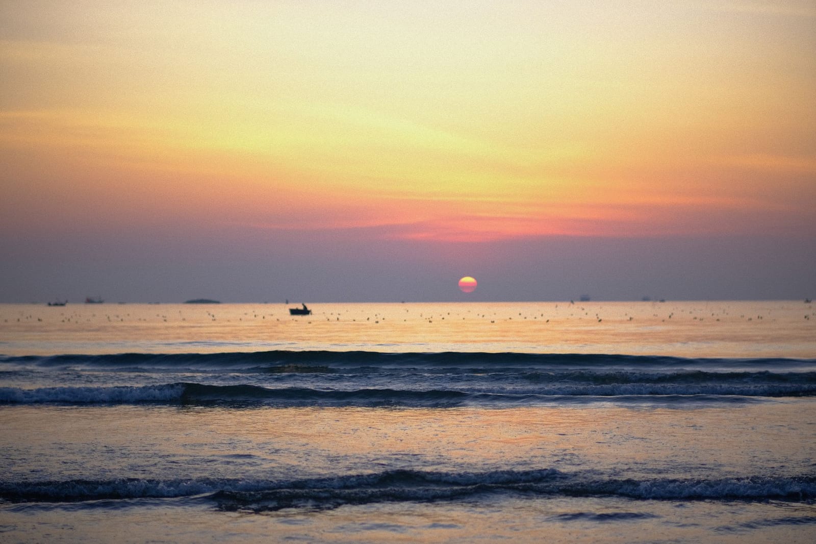 Locals swimming at sunrise on My Khe Beach, Da Nang