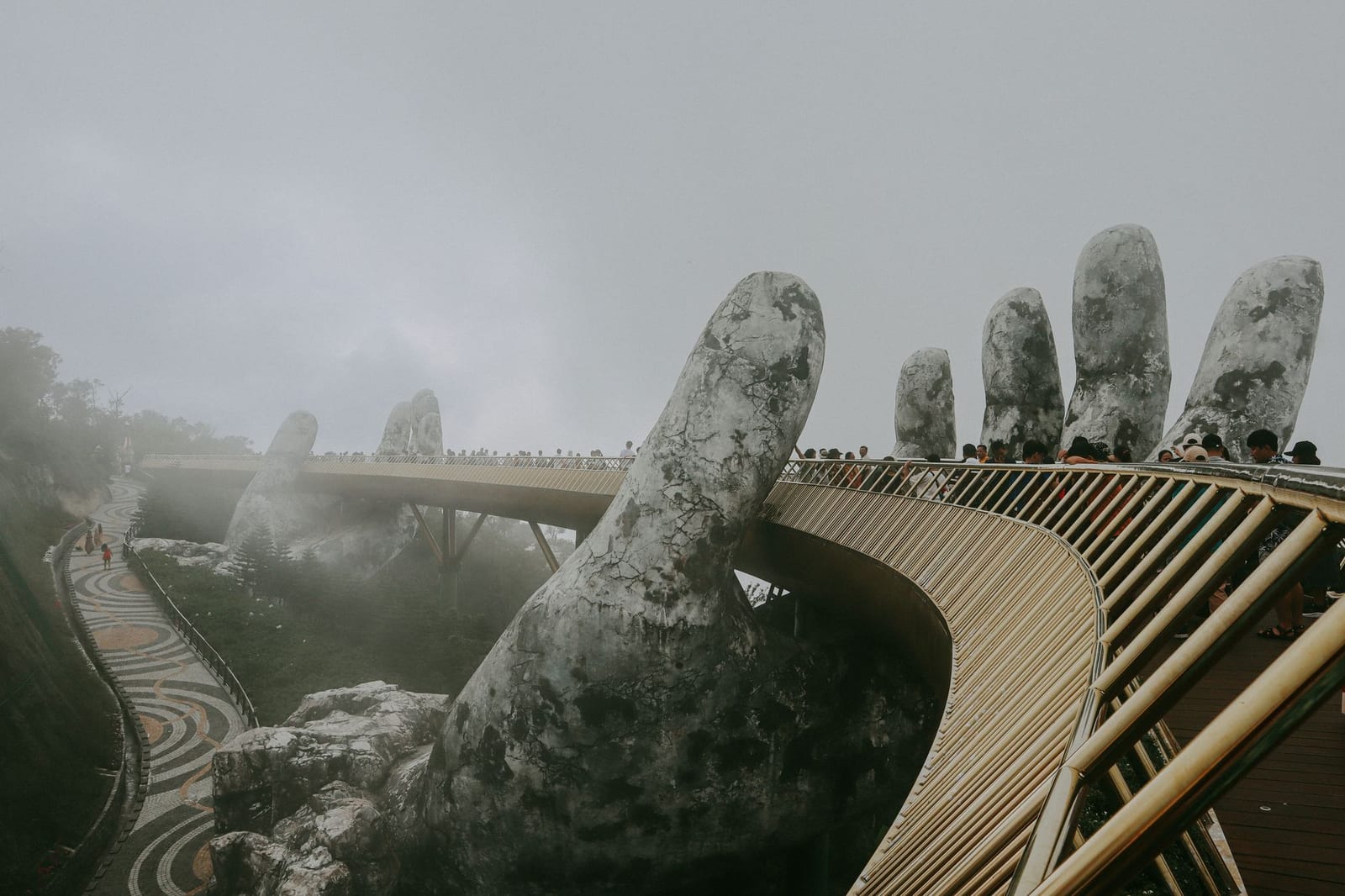 The Golden Bridge held by giant stone hands at Ba Na Hills