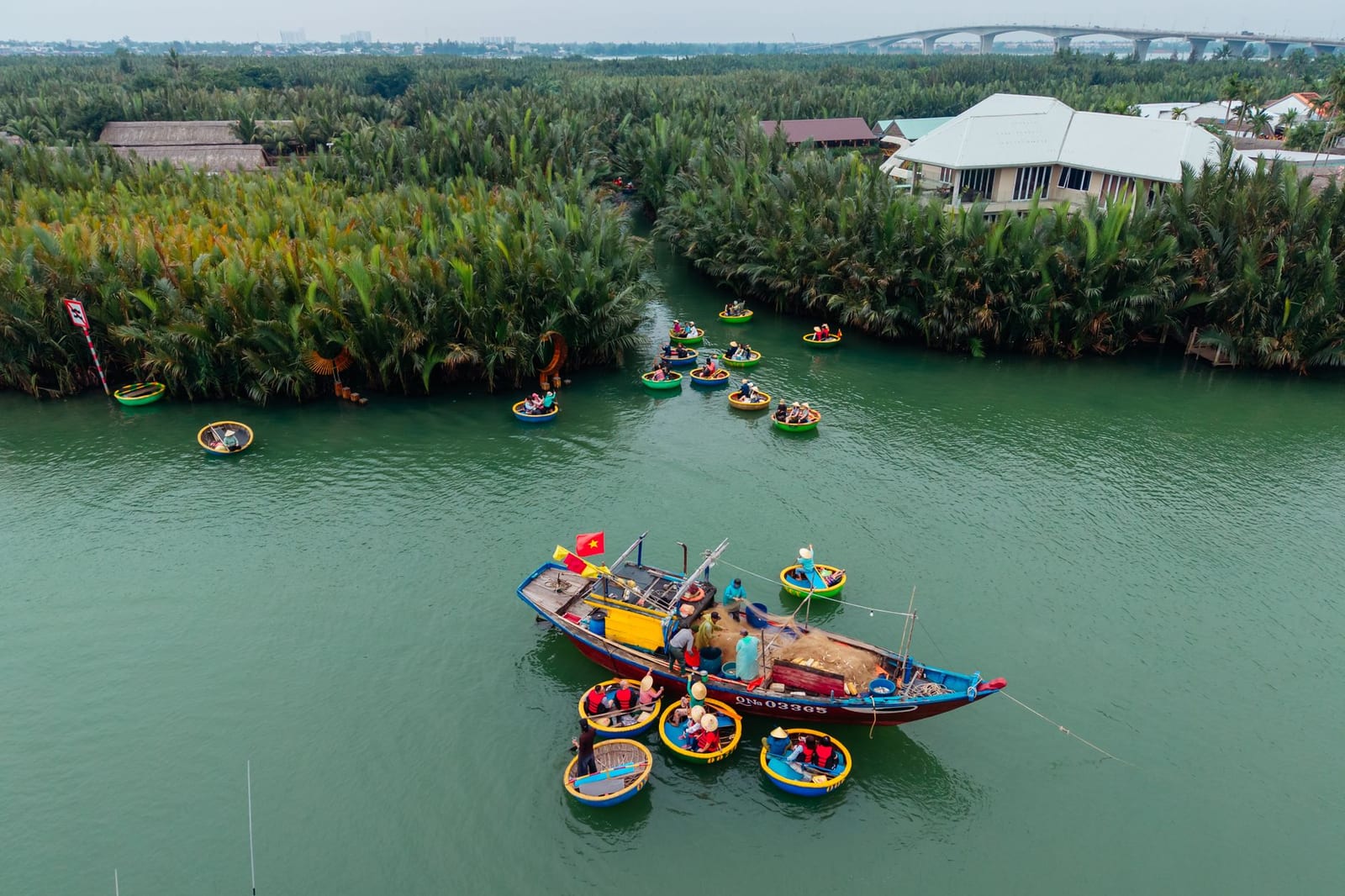 A round basket boat gliding through the Bay Mau Coconut Forest in Cam Thanh, Hoi An