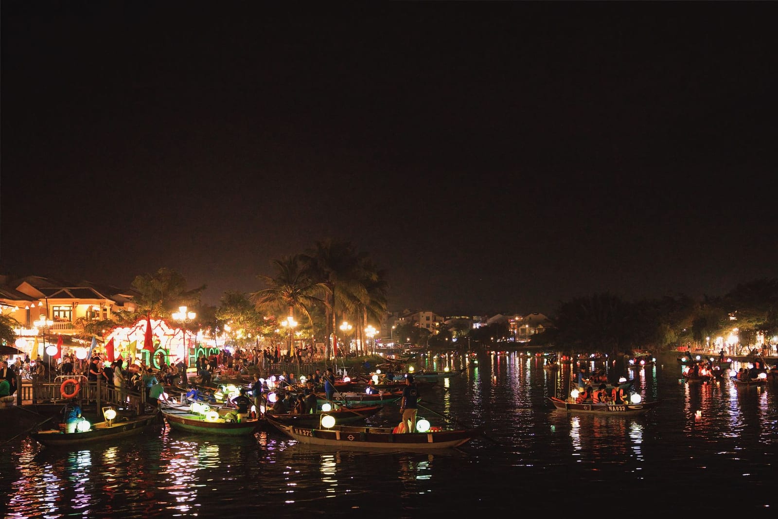 Lantern-lit sampans on the river by the An Hội riverfront in Hội An at night